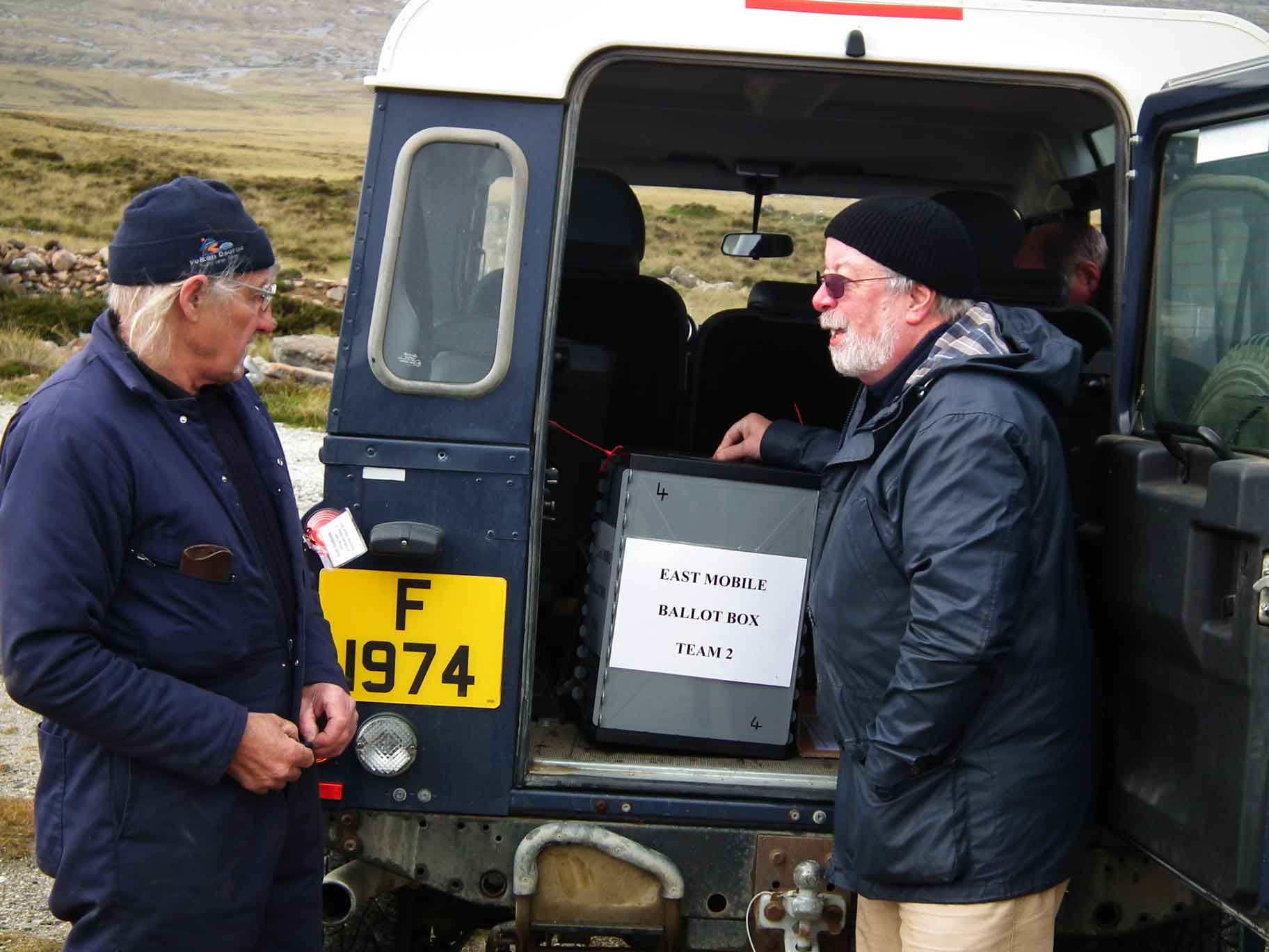 John Fowler puts his ballot paper in the box on the back of a Land Rover at Estancia Junction